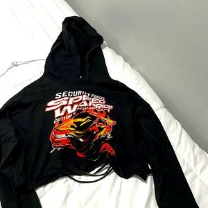 a long sleeve black shirt with a car printed on and a slits going down the front